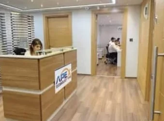 Reception desk with the APEX Technology logo